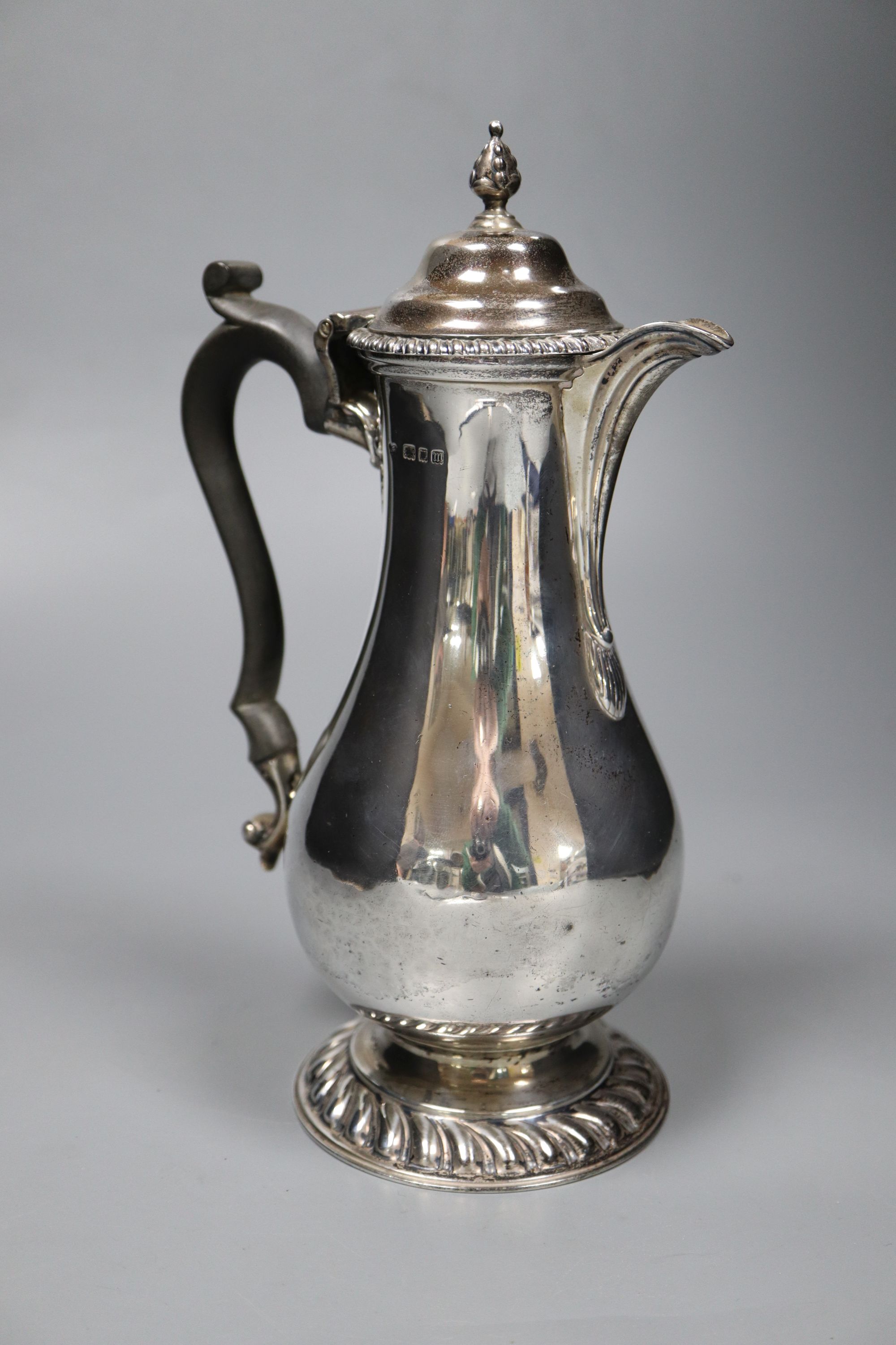 A George V silver baluster hot water pot, with ebonised handle, Goldsmiths & Silversmiths Co Ltd, London, 1927